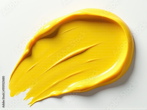 A close-up shot of a bright yellow substance spread out on a clean white surface