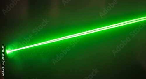 Bright Green Laser Beam Cutting Through Darkness.