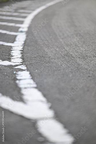 Worn asphalt road with faded white markings