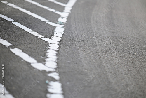 Worn asphalt road with faded white markings