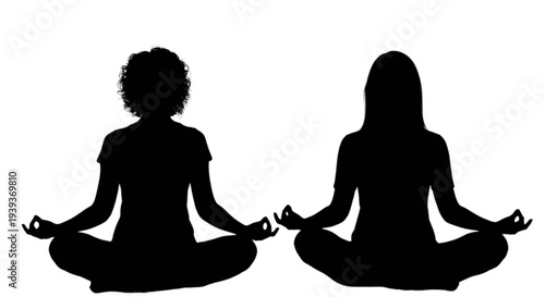 Two women meditating in lotus position