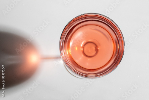 Glowing rose in a crystalline goblet, embodying vinous allure, resonates with International Rose Day and Dionysian revelries