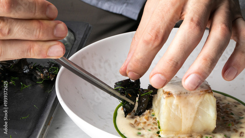 Crafting elegant gourmet cod with wild seaweed, echoing Nordic culinary tradition, evokes Imbolc feast and marine gastronomy rituals