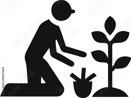 Person kneeling down to plant a sapling with a small gardening tool