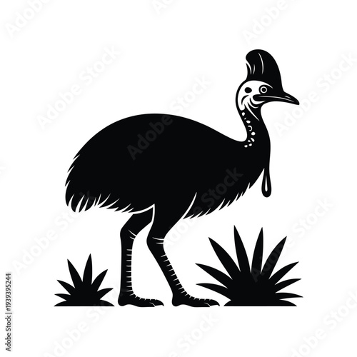 Black silhouette of a cassowary bird standing in foliage