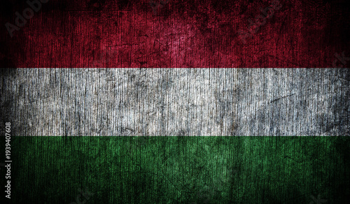 Abstract retro Hungarian flag on a wooden background.