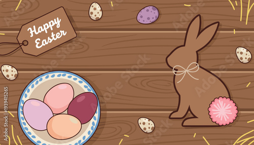 Happy Easter tag with a chocolate bunny and a bowl of pastel eggs on a rustic wooden background with straw for spring celebration