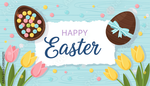 Happy Easter greeting with chocolate eggs, colorful candies, and pink and yellow tulips on a rustic light blue wooden background