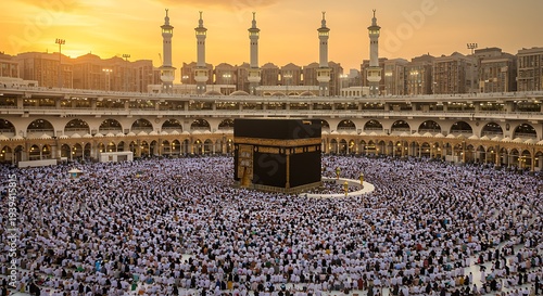 Large crowd of pilgrims surrounds the Kaaba during Hajj pilgrimage at sunset