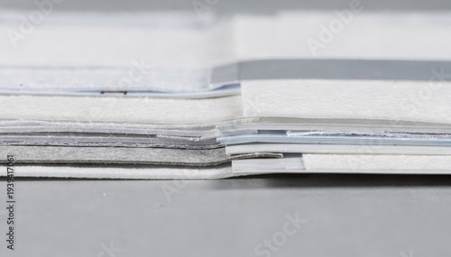 Medium shot capturing the intricate layering of multiple membranes and absorbent pads in multiplex lateral flow test strip lamination for simultaneous detection.