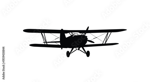 A black silhouette of a vintage biplane against a white backdrop silhouette