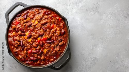A hearty chili con carne with beans cooked in a cast iron pot.