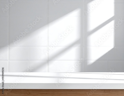 A stark, minimalist composition featuring white tiled wall and surface, bathed in sunlight from a window, creating shadow play