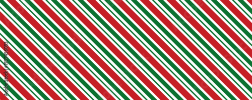 Christmas seamless pattern in classic candy cane design with red and green diagonal stripes on transparent background with 16x9 aspect ratio.