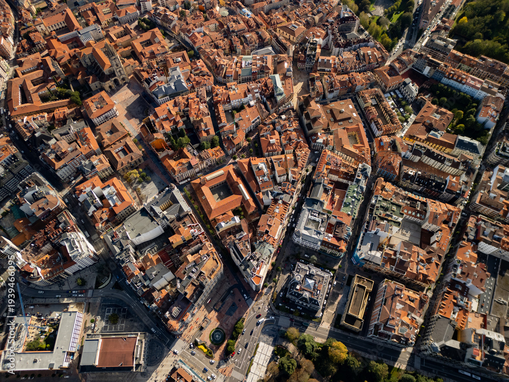 Obraz premium High altitude aerial view of Oviedo old town with terracotta orange roofs, bird's eye perspective of the historic city center in Asturias, Spain, 4K drone
