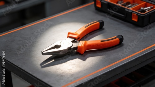 Professional Orange Pliers on Industrial WorkbenchCloseup of Repair Tool with Black and Orange HandleWorkshop Equipment for Maintenance and DIY ProjectsHigh Quality Metal Grip Tool