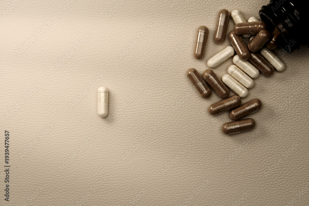 Fototapeta premium Supplements capsules spilling from bottle representing healthcare