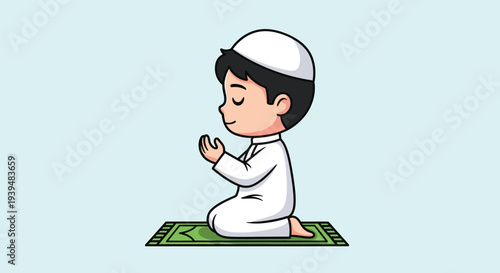 Muslim boy in traditional attire praying on a green prayer mat