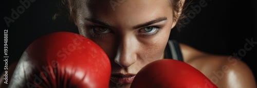A gloved woman engaged in sports boxing