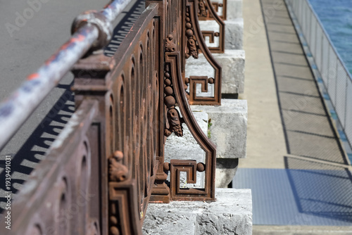 Old, solid, rusty iron railing