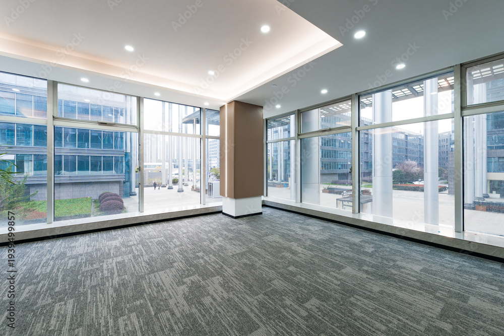 Fototapeta premium Modern office interior with floor-to-ceiling windows and spacious empty layout