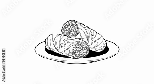 Two cabbage rolls, one cut in half, on a white plate