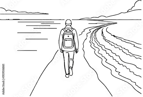 Person walking on a path towards distant mountains and water
