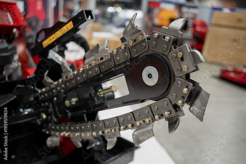 Canvastavla Industrial trenching chain cutter on construction equipment, ground cutting tool