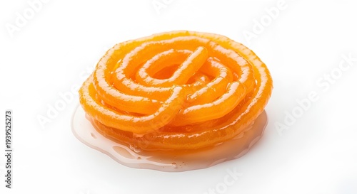 Single Jalebi with Syrup) Close up of a fresh spiral jalebi dipped in golden sugar syrup isolated on white.