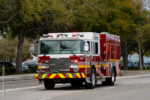 Fotografía Large emergency fire engine driving through an American suburban road in Florida
