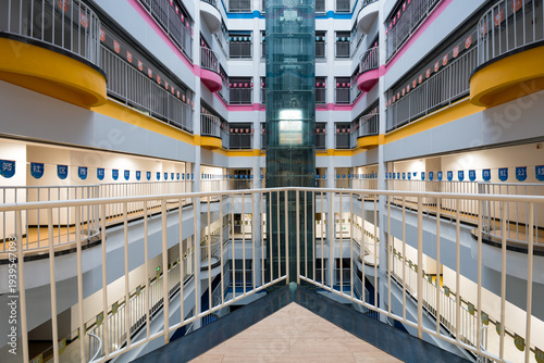 Billede på lærred Modern school atrium with multi-level corridors and a glass elevator