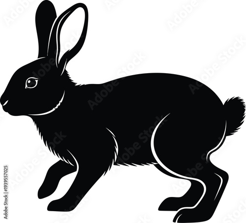 Black silhouette of a hare with long ears in a resting pose