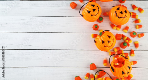 Halloween candy and jack-o-lantern buckets on rustic white wood