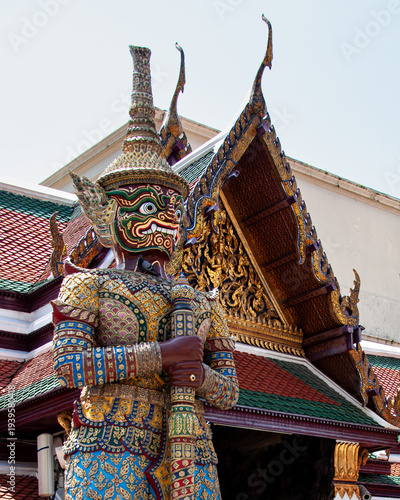 An elaborately decorated Chinese guardian protects a building entrance at Wat Phra Kaeo in Bangkok
