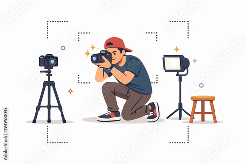 Young photographer kneeling, taking pictures with camera in a studio setup