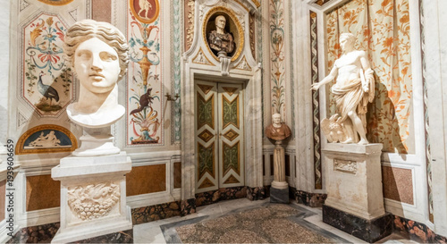 Elegant museum room with ancient marble statues and ornate wall designs