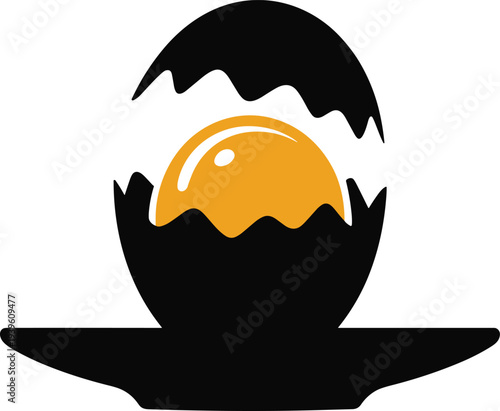 Stunning golden egg emerging from cracked black eggshell