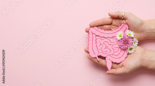 Wallpaper Mural Hands holding pink paper intestines adorned with flowers, promoting gut health awareness. Torontodigital.ca