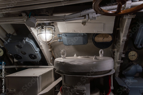 Photography Interior view of a submarine control room with gauges, lights, and machinery com