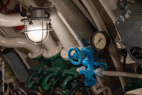 Canvas Print Industrial machinery control panel with blue valve, pressure gauge, and illumina
