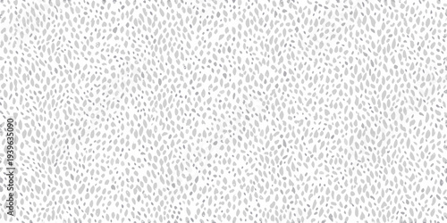 Abstract pattern of small scattered gray shapes on a white background