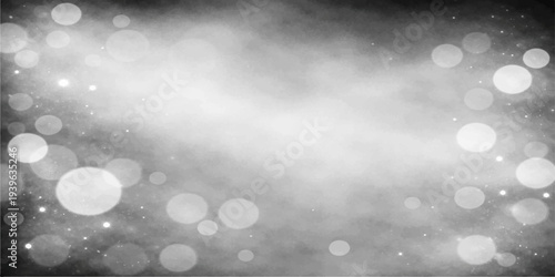 A shimmering winter background featuring bright blue bokeh circles and soft silver glitter in a festive holiday pattern with a defocused glow