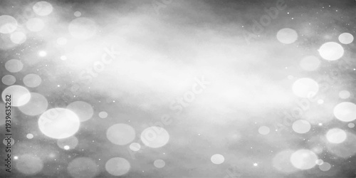 Abstract winter background featuring a bright blue bokeh design with silver glitter and glowing blurred lights creating a festive holiday pattern