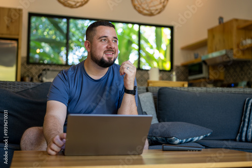 Man working remotely with laptop at home