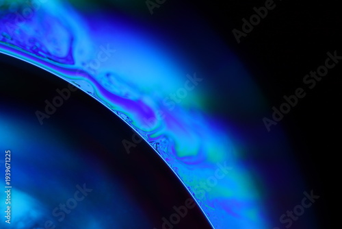 	
Abstract macro shot of blue liquid bubbles and a thin fluid thread. Artistic deep blue lighting creating a futuristic and scientific atmosphere. High-contrast texture with focus on surface tension
