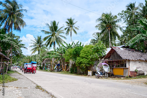 Tropical Village With Roadside Kiosks and Tricycles on a Sunny Day