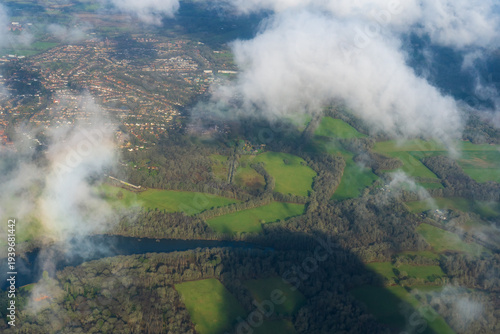 Aerial view of English countryside through scattered clouds. 