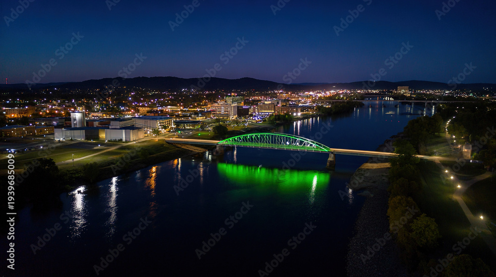 Fototapeta premium Illuminated Bridge Over Nighttime Cityscape