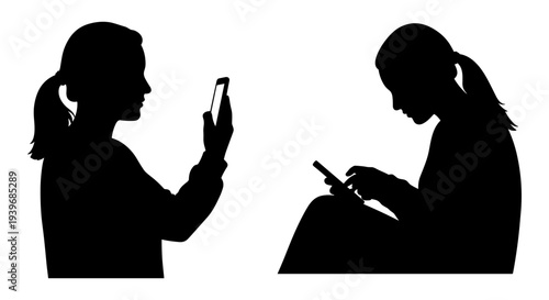 Two black silhouette vector illustrations of young women using smartphones, one standing and holding the phone up, the other sitting and looking down at the device