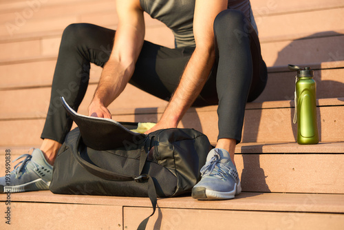 Athlete packing gym bag for workout session